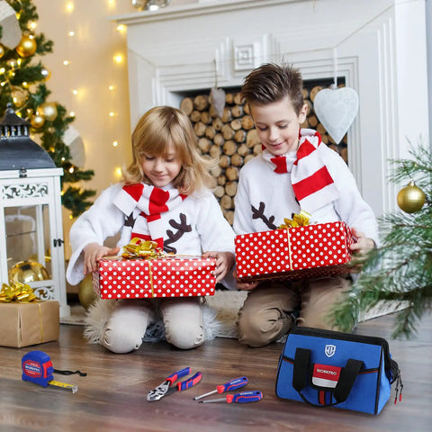 Two children with gifts near a fireplace, beside the 9 Piece Kid Friendly Real Hand Tool Set For Boys And Girls Blue Junior Tool Kit