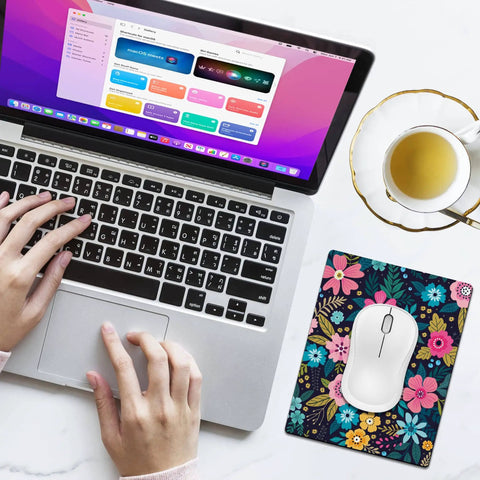 Extra Small Floral Mouse Pad 5.5 by 7 Inches Travel Ready Waterproof and Washable Desk Mat next to a laptop and tea cup