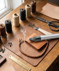 Dang Handy Tungsten Thread Burner Craft Pen For Trimming Frayed Ends Quick, on workbench with threads, scissors, and leather.