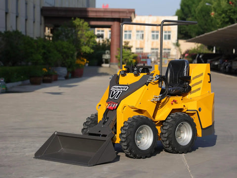 Thunder VI 23.5HP EPA gas engine wheel loader with bucket for construction, farming, and landscaping jobs on sunny site.