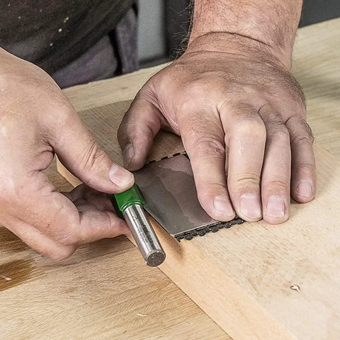 Hands using All In One Credit Card Diamond Sharpening Kit With 180 300 Grit And 600 1000 Grit Stones on a wooden surface.