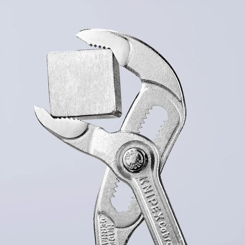 Cobra Water Pump Pliers Chrome With One Handed Adjustment And Guard 27 Position Fine Adjustment Hardened Teeth gripping metal object.