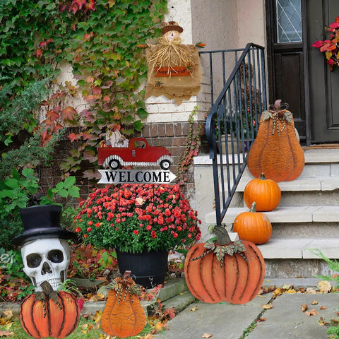 Red Pickup Truck Welcome Sign With Pumpkin Interchangeable Seasonal Yard Stake Garden Decor For Fall Harvest Thanksgiving Halloween Xmas Rustic Outdoor Home Accent displayed among autumn decorations by a porch.