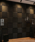 96 Pack Heavy Duty Acoustic Foam Wedge Tiles Soundproofing Wall Panels For Recording Studios mounted on a studio wall with speakers.