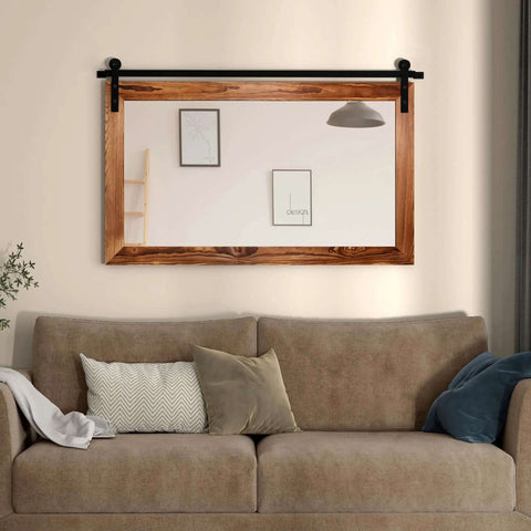 Farmhouse Barn Door Mirror With Rustic Wood Frame 41 By 26 Inches mounted over living room sofa for decor in brown finish