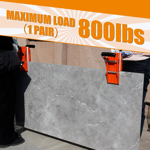 Granite carrying clamps (2-pack), orange with rubber-lined jaws gripping a large gray stone slab
