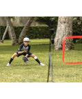 Boy playing with PitchBack Baseball And Softball Pitching Net And Rebounder For Fielding Practice in a park