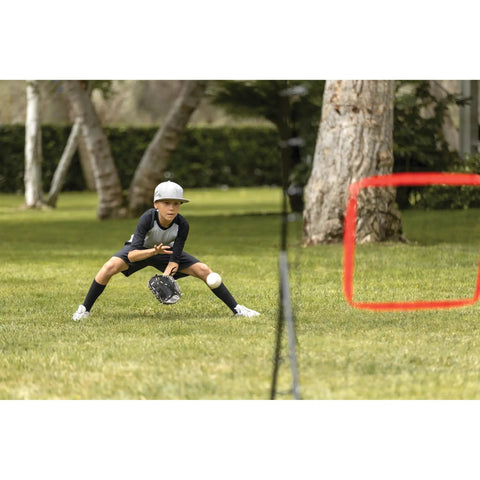 Boy playing with PitchBack Baseball And Softball Pitching Net And Rebounder For Fielding Practice in a park