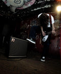 Guitarist playing with 50 Watt Intelligent Guitar Combo Amp With Amp Intelligence, Prompt Photo And Audio Tone Creation