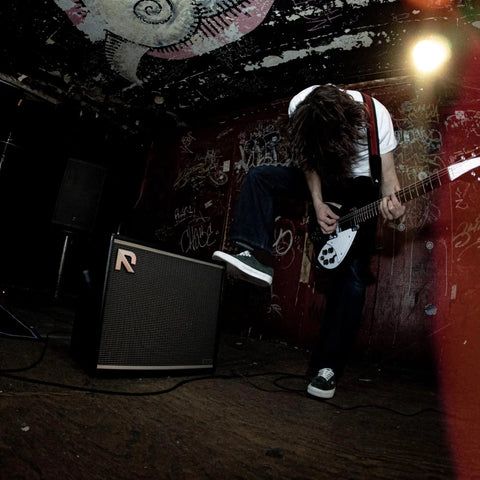 Guitarist playing with 50 Watt Intelligent Guitar Combo Amp With Amp Intelligence, Prompt Photo And Audio Tone Creation