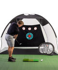 Golfer using Massive 10x7ft Golf Practice Net Kit With Hitting Net Chipping Net Tri Turf Mat And Target Mat For Backyard Driving