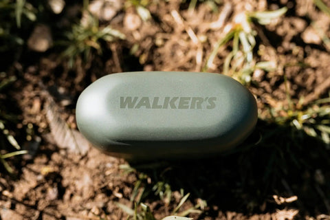 Suppressor Bluetooth Earbuds With 25dB NRR Hearing Protection And HD Sound case on the ground outdoors