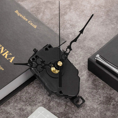 DIY Quartz Clock Movement Kit Replacement Mechanism With 0.9 Inch Pendulum Rod on a book with ornate black hands.