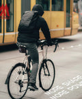 Cyclist riding city street with backpack ready to use All In One Bike Repair Kit With Saddle Bag Tire Tool Mini Pump Multitool