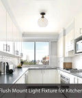 Flush mount light fixture in a modern kitchen with white cabinetry and stainless steel appliances