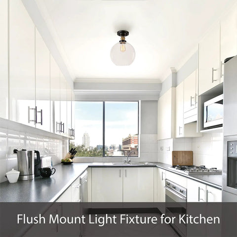 Flush mount light fixture in a modern kitchen with white cabinetry and stainless steel appliances