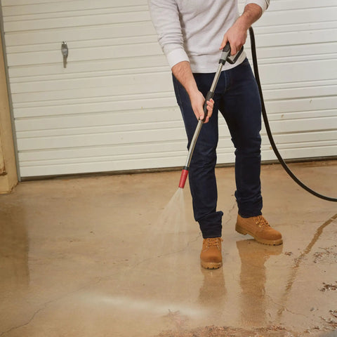 Person using Heavy Duty Watering Wand Sprayer For Garden Hose With Adjustable Tip Rugged Metal Construction on driveway