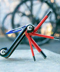 Go To Bike Repair Multitool Kit 9 In 1 for on-the-go fixes with visible hex wrenches and CrV steel construction on cement.