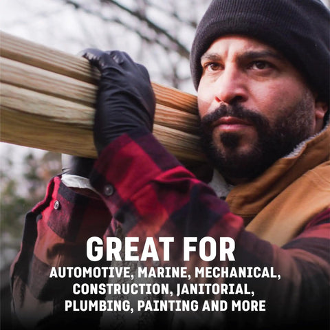 Man wearing heavy duty industrial nitrile gloves carrying wooden beam, highlighting great for various demanding jobs.