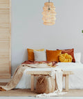 FOREVER BAMBOO Handwoven Indonesian Bamboo Pendant Light, 18 in H x 12 in W hanging over a cozy, minimalist bedroom setting.