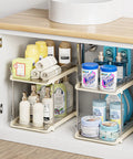 No Fuss Slide Out Two Tier Under Sink Organizer With Reconfigurable Dividers Stackable Pantry Storage Rack In Warm Beige with toiletries.