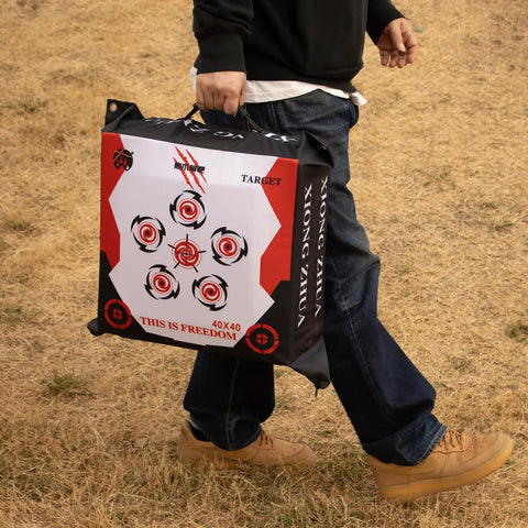 Person carrying Durable Portable Bag Archery Target 40x40 With High Density Core And Removable Inner Core Refills