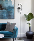 58 Inch Industrial Nautical Floor Lamp With Hanging Cage Shade, Brushed Pewter Finish, in living room next to blue couch
