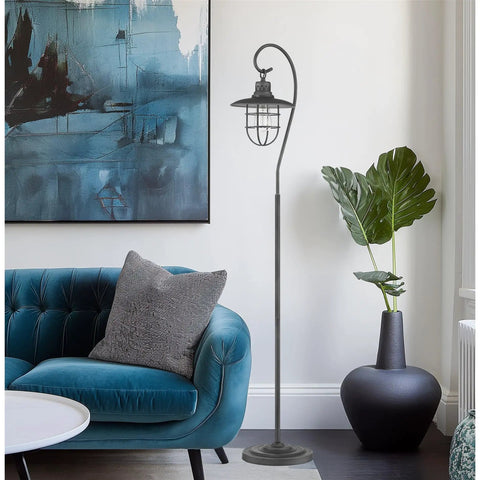 58 Inch Industrial Nautical Floor Lamp With Hanging Cage Shade, Brushed Pewter Finish, in living room next to blue couch