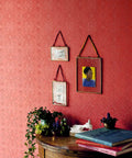 Interior wall with red textured wallpaper, plants, and paintings. Maxwell White Paintable Textured Vinyl Wallpaper Unpasted Washable Strippable 21 In By 33 Ft Double Roll With Straight Match And Six Point Twenty Five Inch Repeat Ideal For DIY Home Makeovers.