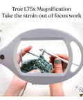 Hands using LightView Pro LED Magnifying Floor Lamp with Full Page Glass Lens for crochet, showing 1.75x magnification detail.