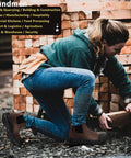 Person wearing Mens Steel Toe Waterproof Work Boots Slip On Safety Shoes With Slip Resistant And Anti Static Design 200J Toecap Wide Toe Box Meets ASTM F2413 I75 C75 EH Durable For Tough Jobs, handling wooden pallets on a construction site.