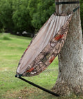 Camo Tree Hammock Chair For Huntin And Camping Portable Lightweight Stool On Tree Stand 360 Degree Swivel Seat Easy Setup Heavy Duty 330 Lb Capacity Outdoor Gear attached to a tree showcasing camouflage fabric and sturdy frame.