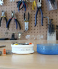 GoTubb Mini Storage Containers For Snacks And Grab And Go Travel Gear With One Hand Snap Lid, clear container in workshop