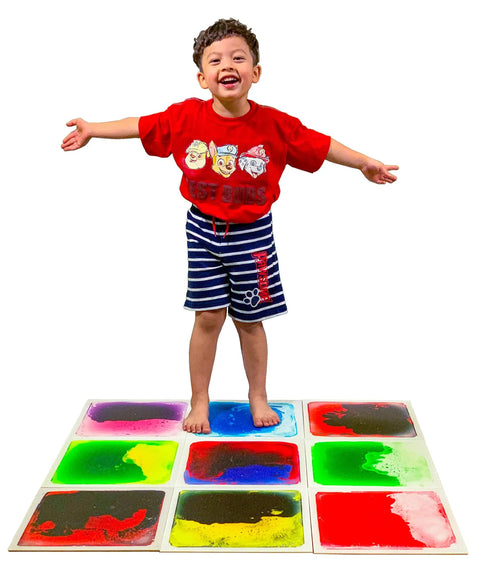 Child standing on Liquid Sensory Floor Tiles 15.8 Inch Square 4 Pack Colorful Fun Non-Toxic Liquid Moves With Every Step