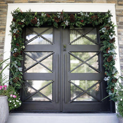 Heavy Duty Adjustable Front Door Garland Hanger With Padded Ends Providing Rock Solid Grip On Jambs From 51 To 81 Inches Holding 20 Lbs Of Decor For Zero Stress Holiday Setup on a decorated black door.