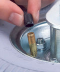 Person installing air valve cap on Smooth Rollin Pneumatic Wheel Caster Set Featuring Two Rigid And Two Swivel Units With Bully Proof Eight Inch Tires And Protective Donut Bumpers Perfect For Heavy Duty Carts And Warehouse Moves.