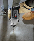 Straight Shooter Heavy Duty Electric Hammer Drill With Variable Speed Trigger And Reliable 6.5 Amp Motor Built To Crush Concrete And Tough Construction Jobs Like A Champ in use drilling through concrete.