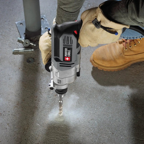 Straight Shooter Heavy Duty Electric Hammer Drill With Variable Speed Trigger And Reliable 6.5 Amp Motor Built To Crush Concrete And Tough Construction Jobs Like A Champ in use drilling through concrete.