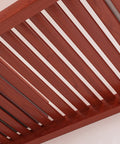 Close-up view of Rock Solid Hardwood Reach In Closet System shelf with rich red mahogany finish and smooth glide rod.