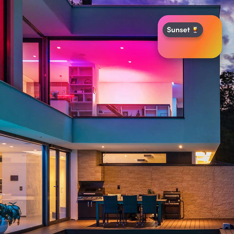 Modern home with Crazy Bright Supercolor BR30 Smart Flood Bulbs 2 Pack RGB Plus Tunable White lighting from outside at sunset.