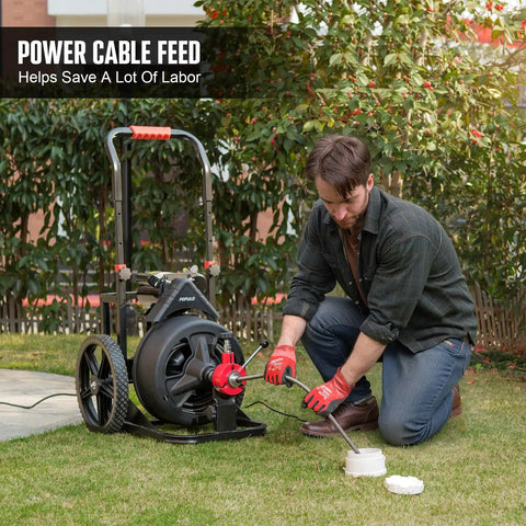 Person using 100 Foot Auto Feed Electric Drain Snake Auger For 2 To 4 Inch Pipes to clear a drain outdoors.