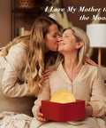 Two women sharing a moment with a Large Moon Lamp 7.1-Inch With Wooden Base, Touch Dimmable Dual Color Night Light gift in box.
