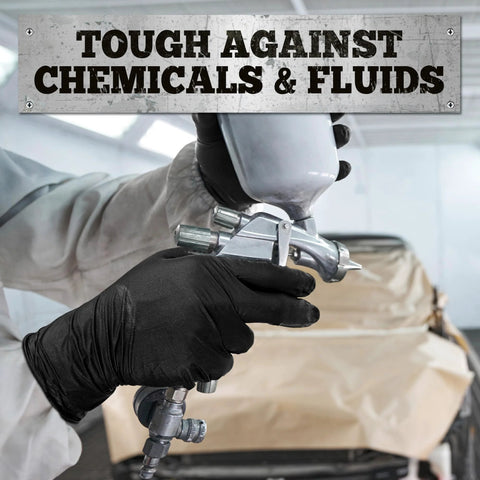Close-up of hands wearing black nitrile gloves holding a paint spray gun