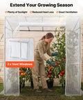 Woman tending plants inside Walk In Greenhouse For Outdoors With Windows PE Cover Roll Up Zipper Door 76.8 x 30.3 x 66.1 Inches