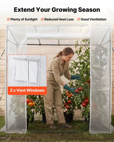 Woman tending plants inside Walk In Greenhouse For Outdoors With Windows PE Cover Roll Up Zipper Door 76.8 x 30.3 x 66.1 Inches