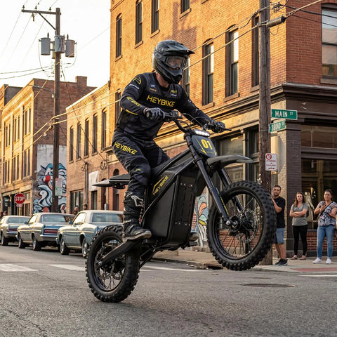 Dual Pack Off Road Beast Mode Electric Dirt Bike With 4160W Mid Drive Motor And 52V 26Ah Battery rocking fat tires on a city street.
