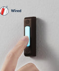 Wired Push Doorbell Button In Oil-Rubbed Bronze Metal Finish, Lighted Surface-Mount Outdoor Doorbell Button For Home Improvement, Weatherproof Low-Voltage Max 16V, Easy Install And Durable. Finger pressing lit button on wall