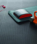 Interlocking 18 By 18 Inch Raised Coin Floor Tiles For Home Gym Garage Basement Black 24 Pack Durable Plastic Flooring With Easy Snap Installation That Snap Tight For Quick Setup And Last For Years, shown under exercise equipment.