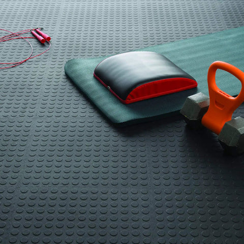 Interlocking 18 By 18 Inch Raised Coin Floor Tiles For Home Gym Garage Basement Black 24 Pack Durable Plastic Flooring With Easy Snap Installation That Snap Tight For Quick Setup And Last For Years, shown under exercise equipment.