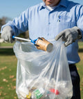 Person using 33 Gallon Clear Trash Liners, Heavy Duty High Density Garbage Bags, 33 By 40 Inches, 500 Count, Leak Proof And Tear Resistant